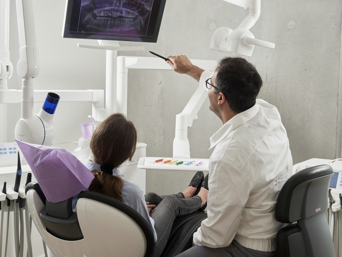 Dentist reviewing X-rays with a patient